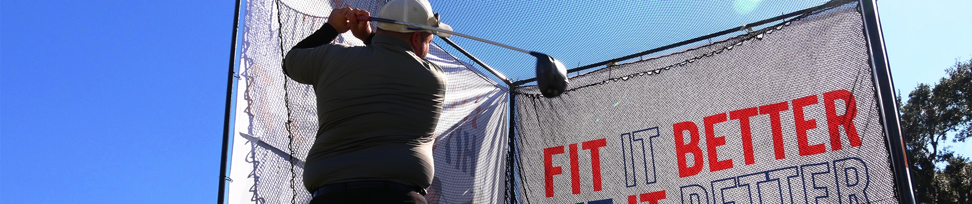 Golfer hitting his Driver into a net